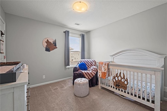 carpeted bedroom featuring a textured ceiling