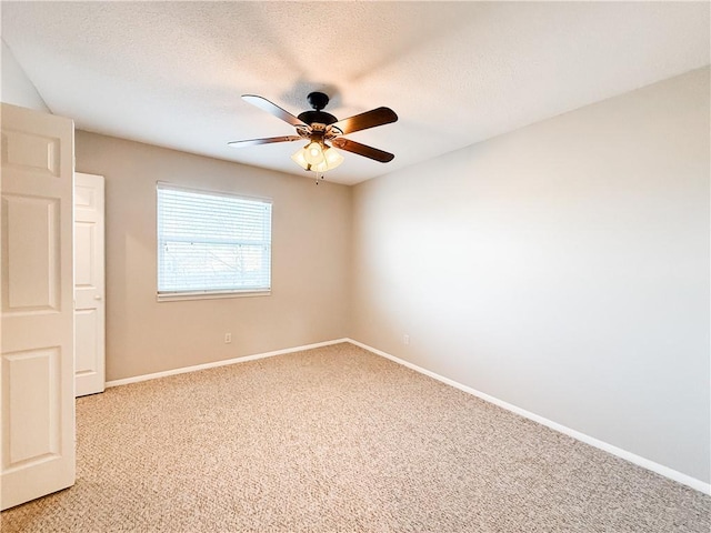 carpeted spare room featuring ceiling fan and a textured ceiling