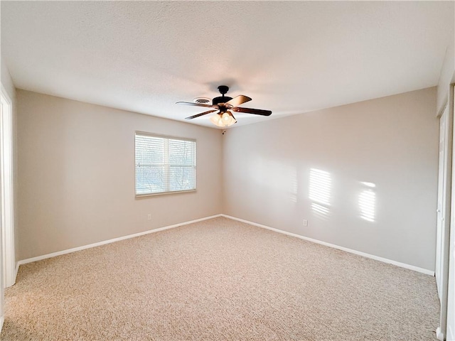 carpeted empty room with a textured ceiling and ceiling fan