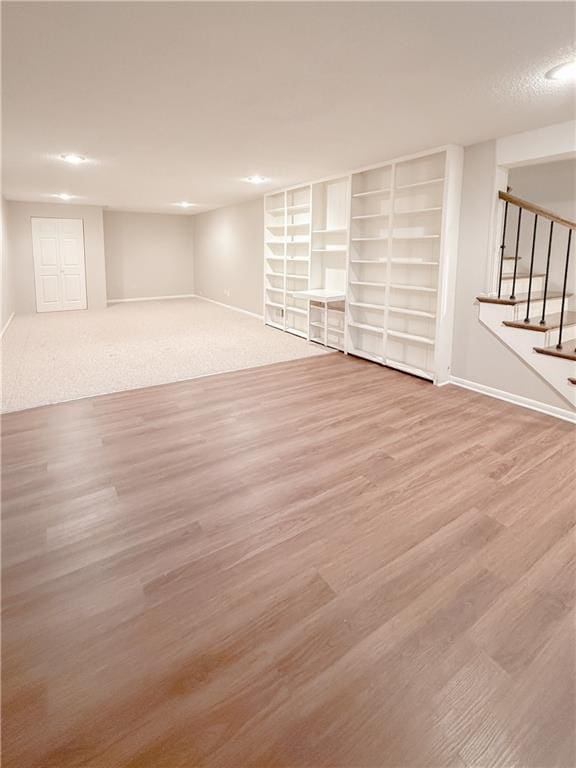 basement with hardwood / wood-style floors