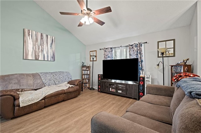 living room featuring vaulted ceiling, ceiling fan, and light hardwood / wood-style floors