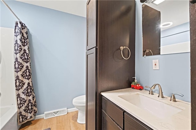 full bathroom with shower / bath combination with curtain, vanity, toilet, and hardwood / wood-style floors