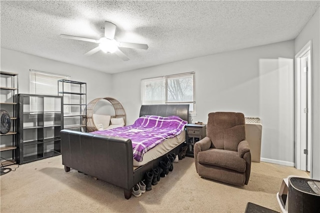 carpeted bedroom with ceiling fan and a textured ceiling