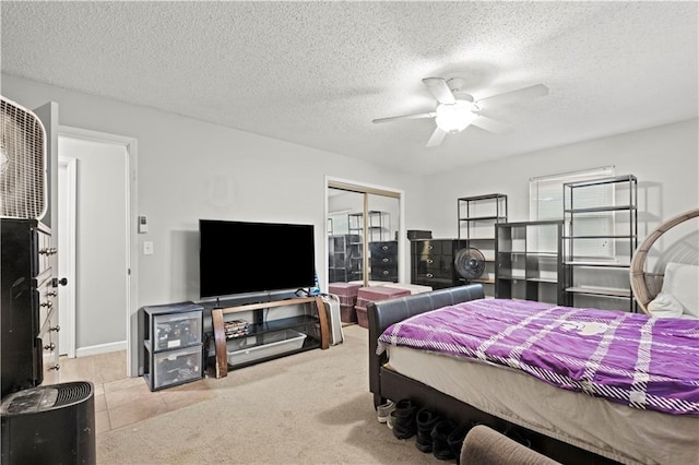 carpeted bedroom with ceiling fan, a textured ceiling, and a closet