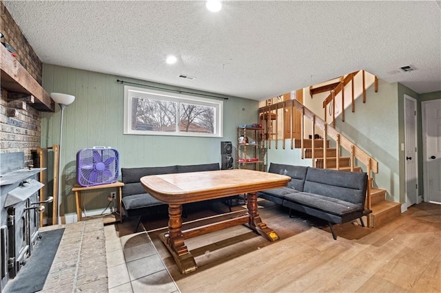 living room with hardwood / wood-style floors and a textured ceiling