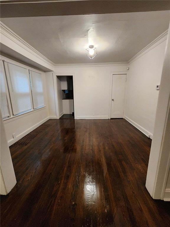 unfurnished room featuring crown molding and dark hardwood / wood-style floors