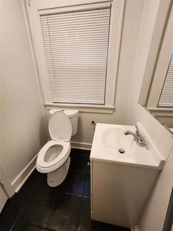 bathroom with tile patterned flooring, vanity, and toilet