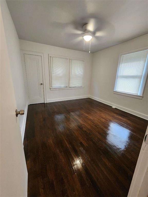 spare room featuring ceiling fan and dark hardwood / wood-style floors