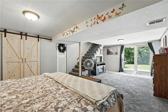 746 Salem Rd, Excelsior Springs, MO 64024 - carpeted bedroom featuring access to exterior, a textured ceiling, and a barn door
