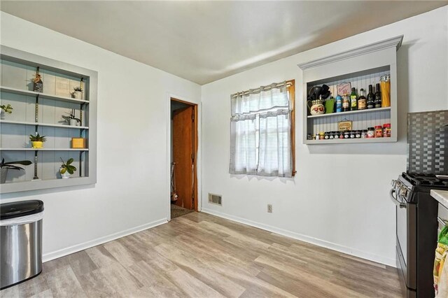 746 Salem Rd, Excelsior Springs, MO 64024 - unfurnished dining area featuring wood finished floors and baseboards
