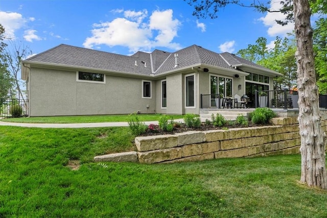24982 W 106th Ct, Olathe, KS 66061 - rear view of house with stucco siding and a lawn