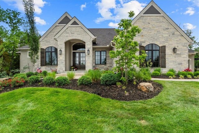 24982 W 106th Ct, Olathe, KS 66061 - french country inspired facade featuring stone siding and a front yard