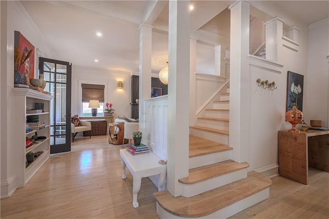 stairs with recessed lighting, crown molding, and hardwood / wood-style floors