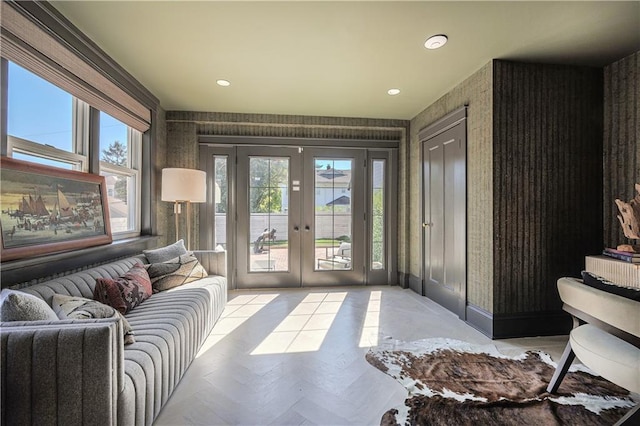 interior space featuring a healthy amount of sunlight, french doors, and wallpapered walls