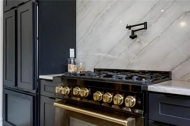 kitchen featuring gas range, gray cabinets, and light countertops