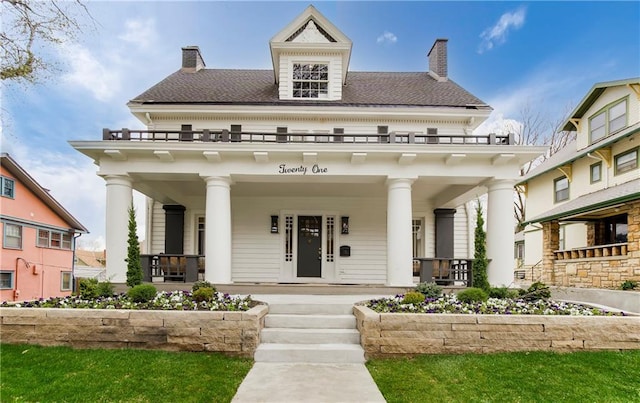 view of front of property with a porch and a chimney