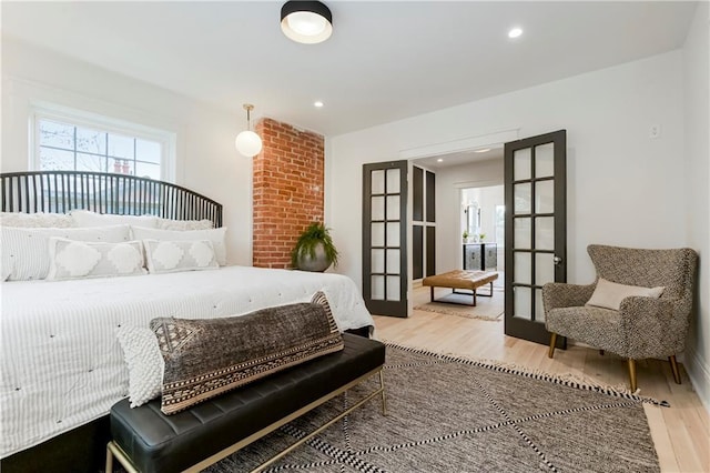 bedroom featuring recessed lighting, light wood-style floors, and french doors