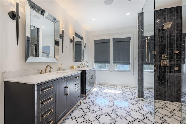 bathroom with a sink, two vanities, and walk in shower