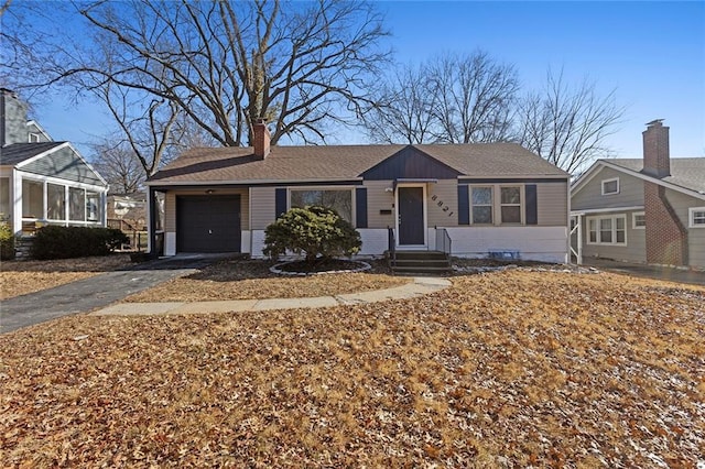 ranch-style home with a garage and a sunroom