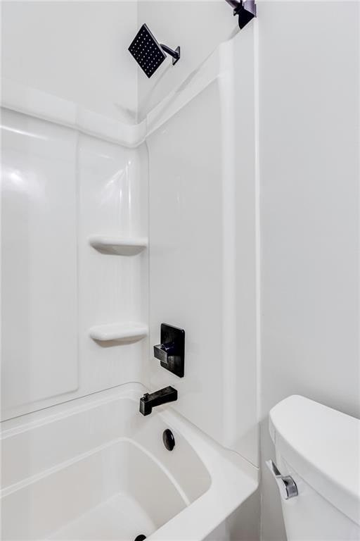 bathroom with shower / tub combination and toilet