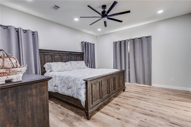 bedroom with ceiling fan and light hardwood / wood-style flooring