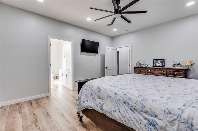 bedroom with ceiling fan, ensuite bath, and light wood-type flooring