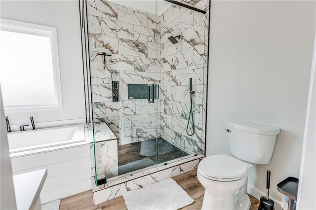 bathroom featuring hardwood / wood-style flooring, plus walk in shower, and toilet