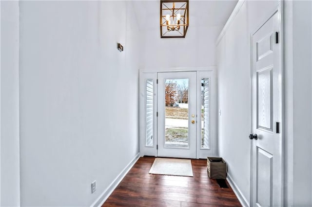 doorway featuring dark wood-type flooring and an inviting chandelier