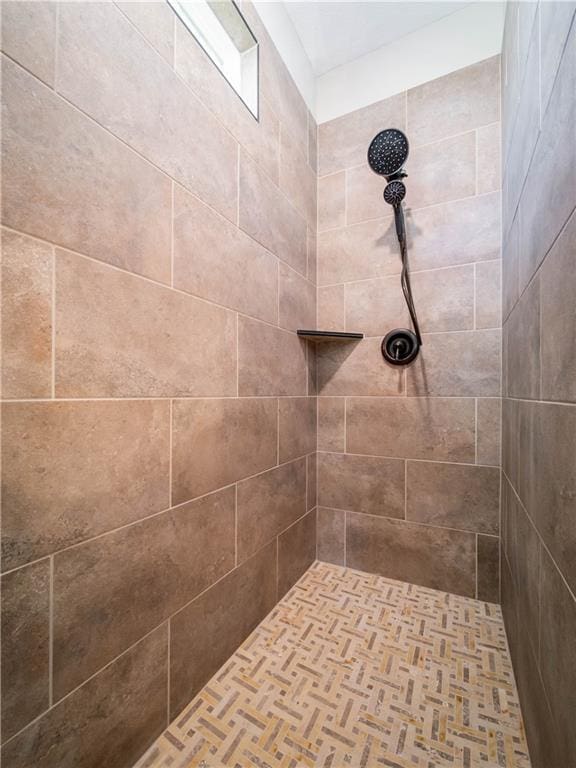 bathroom with tiled shower