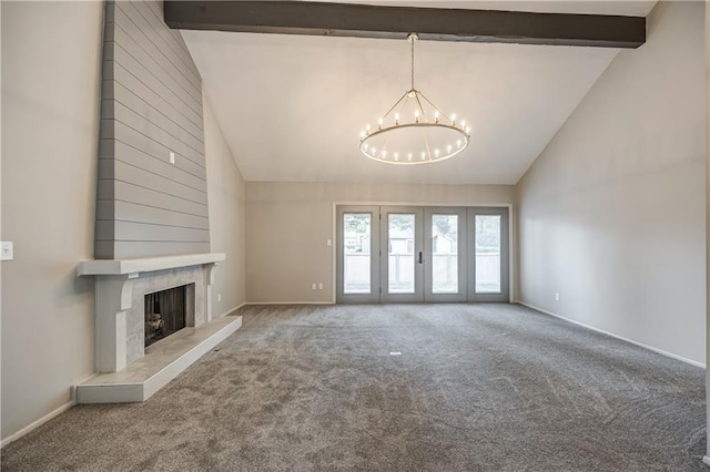 unfurnished living room featuring an inviting chandelier, high vaulted ceiling, carpet, a high end fireplace, and beamed ceiling