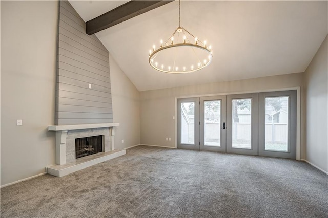 unfurnished living room with an inviting chandelier, a high end fireplace, and carpet