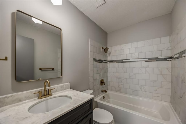 full bathroom featuring vanity, toilet, and tiled shower / bath combo