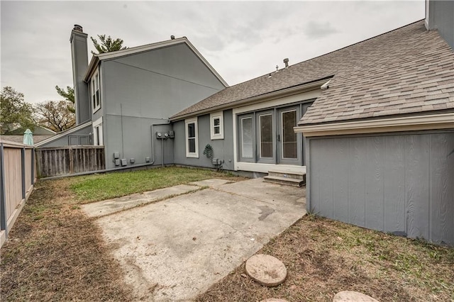 rear view of property featuring a yard and a patio area