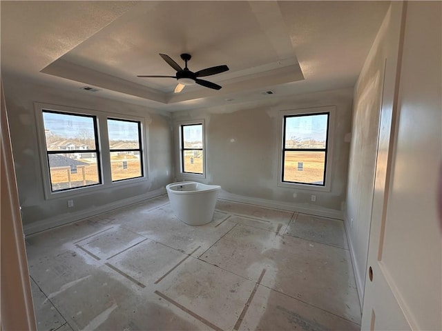 bathroom with a tray ceiling and ceiling fan