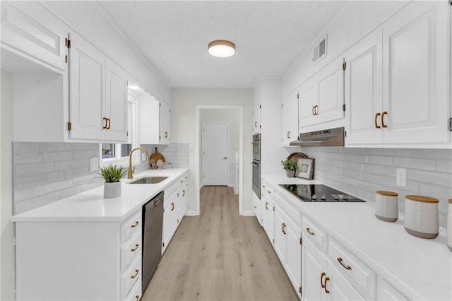 kitchen featuring stainless steel appliances, sink, light hardwood / wood-style flooring, and white cabinets