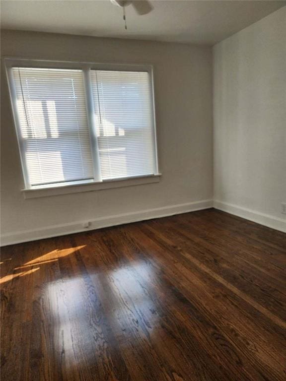 spare room featuring ceiling fan and dark hardwood / wood-style flooring