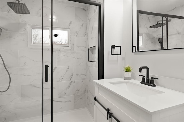 bathroom featuring vanity and a marble finish shower