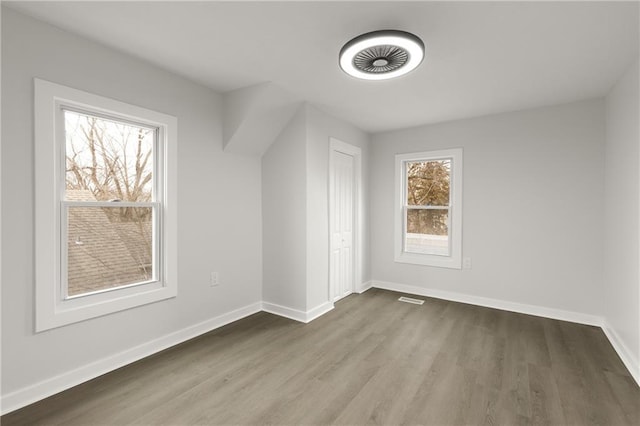 bonus room with visible vents, baseboards, and wood finished floors