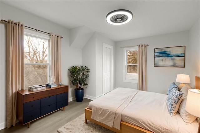 bedroom with light wood-style flooring and baseboards