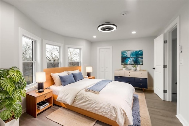 bedroom with baseboards, light wood-style flooring, and recessed lighting