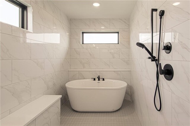 2327 Fishing Ln, Kearney, MO 64060 - full bath featuring a soaking tub, a tile shower, tile walls, and tile patterned flooring