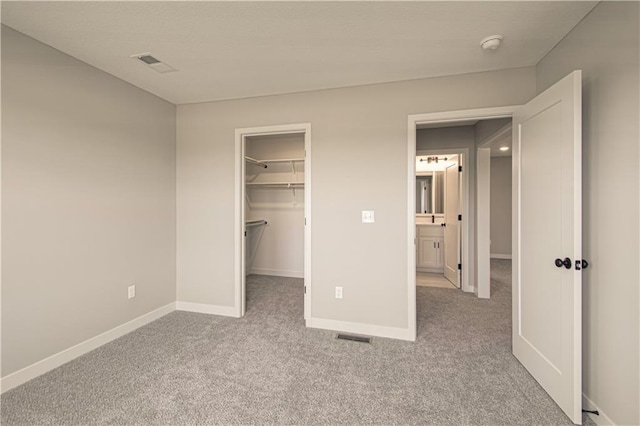 2327 Fishing Ln, Kearney, MO 64060 - unfurnished bedroom with carpet, baseboards, a walk in closet, and a closet