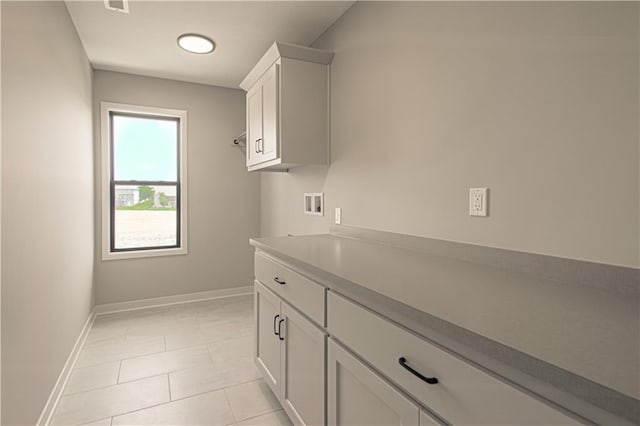 2327 Fishing Ln, Kearney, MO 64060 - laundry area with cabinet space, hookup for a washing machine, baseboards, and light tile patterned floors