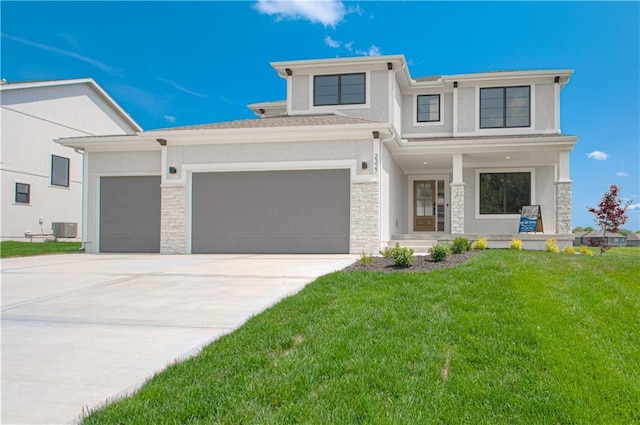 2327 Fishing Ln, Kearney, MO 64060 - view of front of property featuring stone siding, a front yard, central AC, concrete driveway, and an attached garage