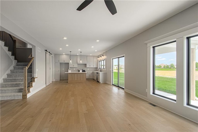 2327 Fishing Ln, Kearney, MO 64060 - unfurnished living room featuring light wood-type flooring, stairs, a ceiling fan, recessed lighting, and baseboards