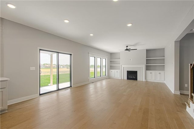 2327 Fishing Ln, Kearney, MO 64060 - unfurnished living room featuring a fireplace, a ceiling fan, light wood-style flooring, baseboards, and recessed lighting
