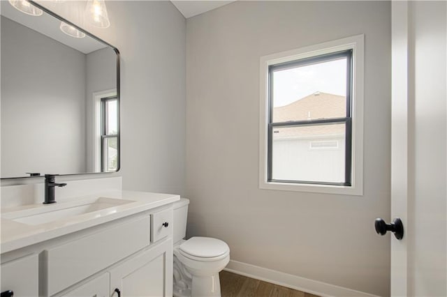 2327 Fishing Ln, Kearney, MO 64060 - bathroom with vanity, toilet, wood finished floors, and baseboards