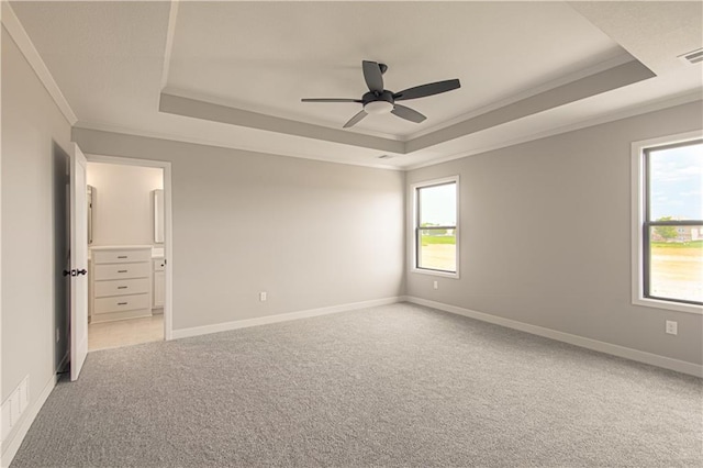 2327 Fishing Ln, Kearney, MO 64060 - spare room with a tray ceiling, crown molding, light colored carpet, healthy amount of natural light, and ceiling fan