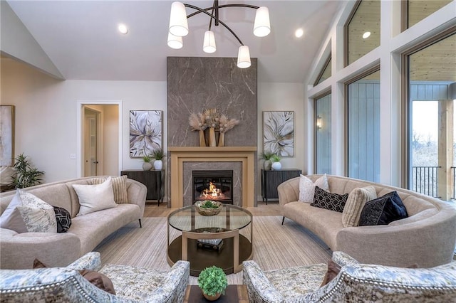 living room featuring vaulted ceiling and a premium fireplace