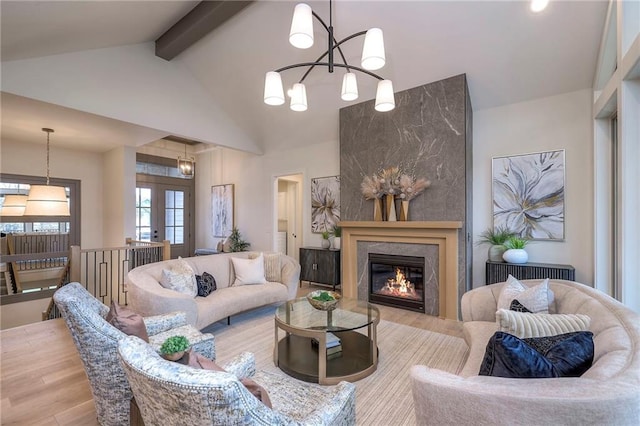 living room with radiator heating unit, wood-type flooring, vaulted ceiling with beams, an inviting chandelier, and french doors